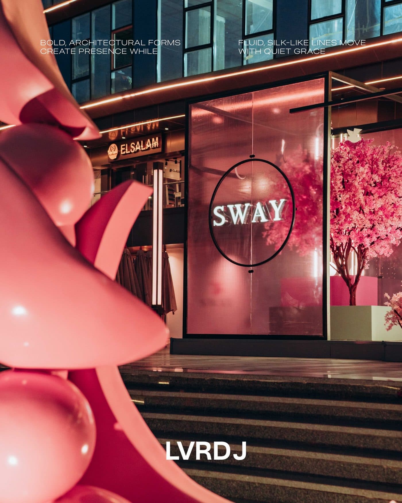 SWAY façade at night with pink blossom installation